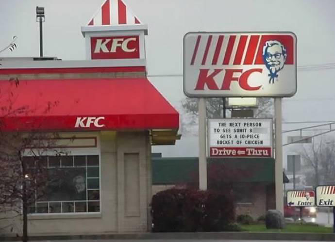 Waterloo Kentucky Fried Chicken restaurant sign that reads "The next person to see Sumit B. gets a 10-piece bucket of chicken."